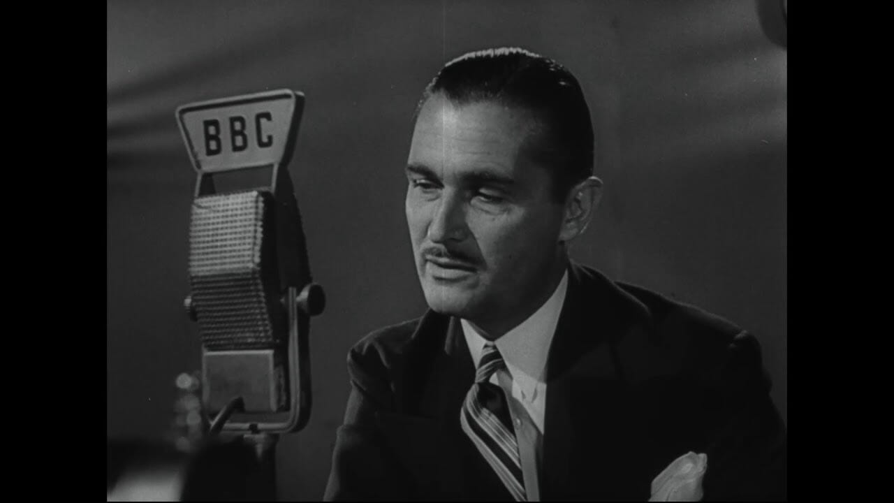 A picture of a man in front of a microphone